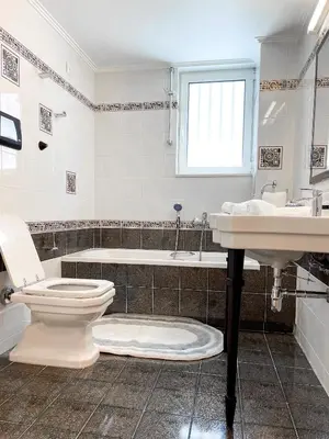 a bathroom with a toilet and a sink and a tub at NJ Apartments: The Island Edition in Rhodes Town