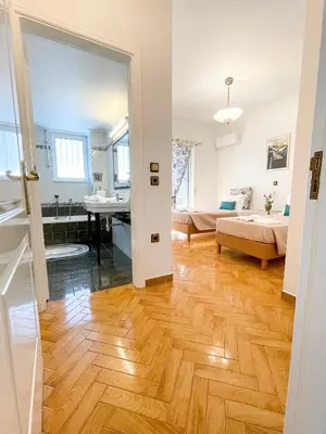 a room with a bedroom and a bed and a bathroom at NJ Apartments: The Island Edition in Rhodes Town