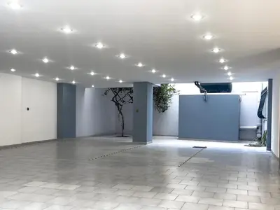 a large room with white walls and lights on the ceiling at NJ Apartments: The Island Edition in Rhodes Town