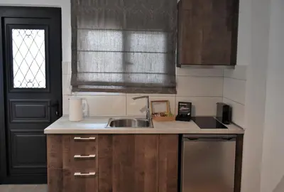 a small kitchen with a sink and a window at Aethrèa Apartments in Haraki