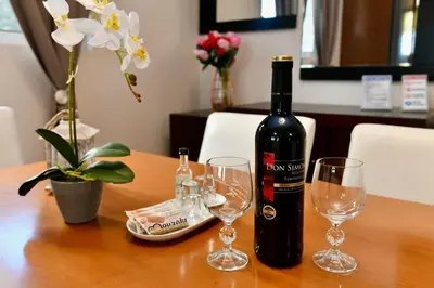 a bottle of wine sitting on a table with glasses at Angels Villa in Kremasti