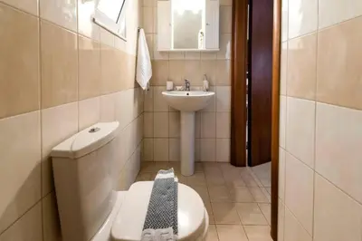 a bathroom with a toilet and a sink at Angels Villa in Kremasti