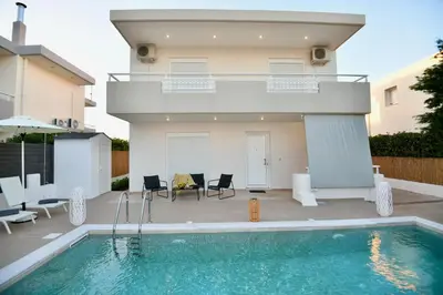 a villa with a swimming pool and a house at Angels Villa in Kremasti