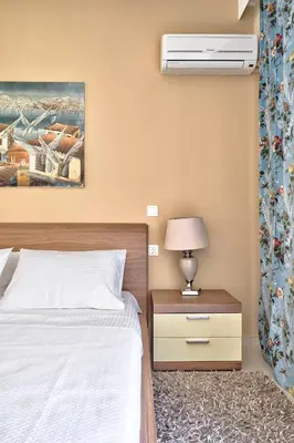 a bedroom with a bed and a air conditioner at Academia in Rhodes Town