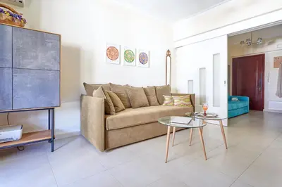a living room with a couch and a table at Academia in Rhodes Town