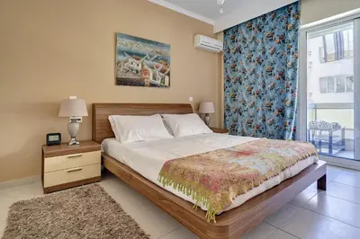 a bedroom with a large bed and a window at Academia in Rhodes Town