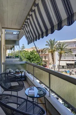 a balcony with tables and chairs and a view at Academia in Rhodes Town