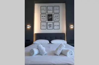 a bedroom with a bed with white pillows on it at Luxury 1 bedroom apartment in Ialysos in Ialyssos