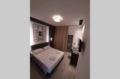 a small bedroom with a bed in a room at Luxury 1 bedroom apartment in Ialysos in Ialyssos