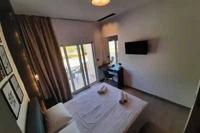 a living room with a couch and a table at Luxury 1 bedroom apartment in Ialysos in Ialyssos