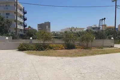 a park with trees and flowers in a city at Luxury 1 bedroom apartment in Ialysos in Ialyssos