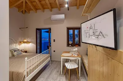a room with a bed and a projection screen at Althea Apartments 2 in Halki
