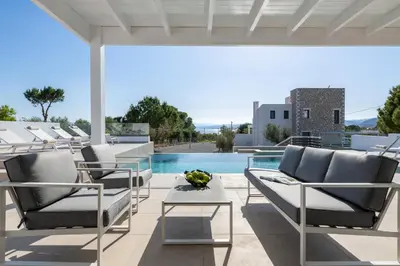 a patio with lounge chairs and a swimming pool at VILLA IRIS in PEFKOS, PINE VILLAS in Pefki Rhodes