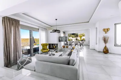 a living room with a couch and a table at Brillante Villa in Ialyssos