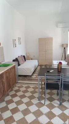 a living room with a bed and a table at San Marco Guesthouse in Kattavía