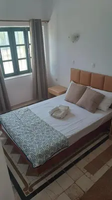 a large bed in a room with a window at San Marco Guesthouse in Kattavía