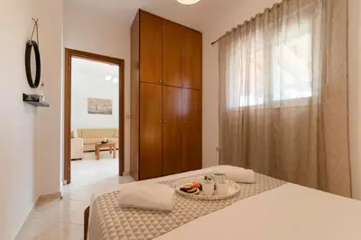 a bedroom with a bed with a bowl of fruit on it at Reni Garden House in Afantou
