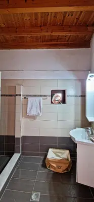 a bathroom with a shower and a sink and a towel at Yiannis Village house in Asklipiḯon