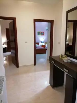 a living room with a kitchen and a bedroom at MARIALENAS HOUSE in Archangelos