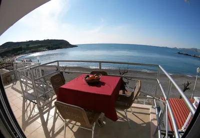 a table on a balcony with a view of the ocean at Aegean Seaview in Haraki