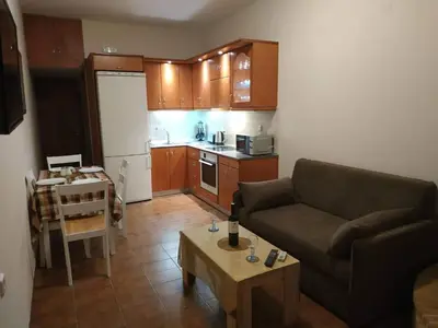 a living room with a couch and a table at Aegean Seaview in Haraki