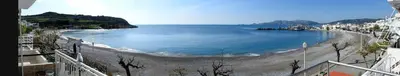 a view of a beach with the ocean and buildings at Aegean Seaview in Haraki