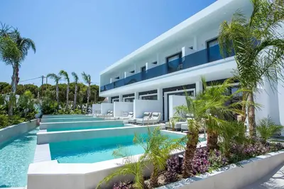 an exterior view of a house with a swimming pool at Vanik Suites in Faliraki