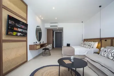 a living room with a bed and a couch at Vanik Suites in Faliraki