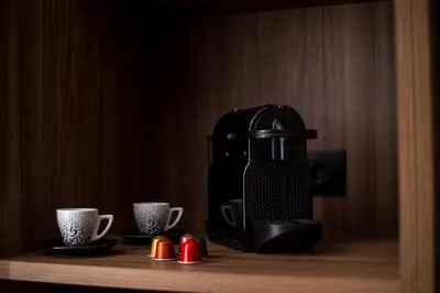 a coffee maker and two cups on a table at Vanik Suites in Faliraki