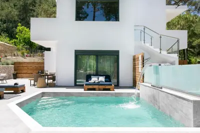 a swimming pool in a backyard with a house at DASÝLIO - earthy living homes in Triánta