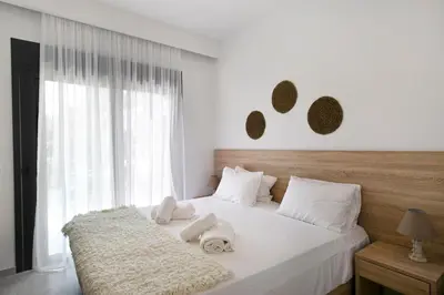 a bedroom with a bed with towels on it at DASÝLIO - earthy living homes in Triánta