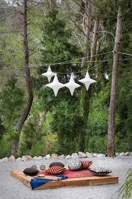 a table with four stars hanging from a string at DASÝLIO - earthy living homes in Triánta