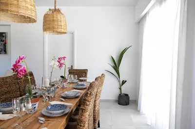 a dining room with a long wooden table with chairs at DASÝLIO - earthy living homes in Triánta
