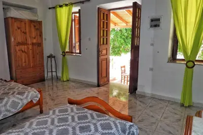 a bedroom with a bed and a door to a patio at Traditional Villa Efterpi in Halki