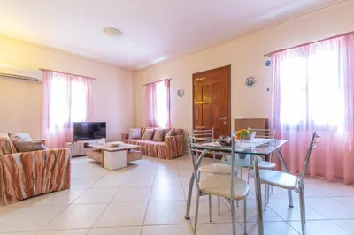 a living room with a table and a couch at Vila Elion Myloi in Symi