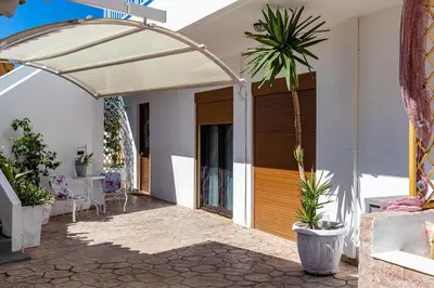 an arbor over a front door of a house with plants at Evi's Afandou Suite in Afantou