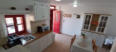 a kitchen with a sink and a red door at VILLA ELENA in Halki