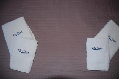 two towels with the words wills spa on them on a bed at VILLA ELENA in Halki