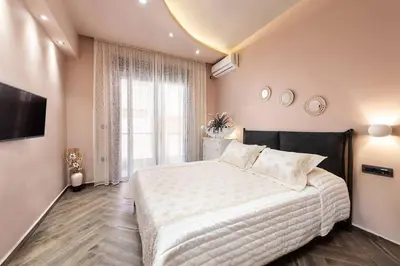 a bedroom with a large bed and a large window at Lux City Apartment in Rhodes Town