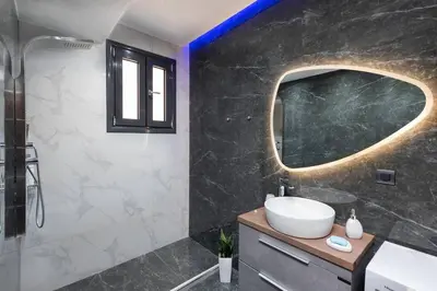 a bathroom with a sink and a mirror at Lux City Apartment in Rhodes Town