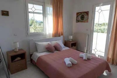 a bedroom with a bed with two towels on it at Villa George Rhodes in Archangelos