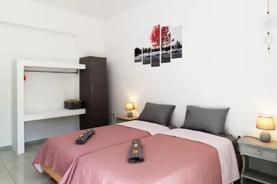 a bedroom with two beds and a mirror at Atlantic Cave Haven-Seaside, Fully Equipped in Kolimbia