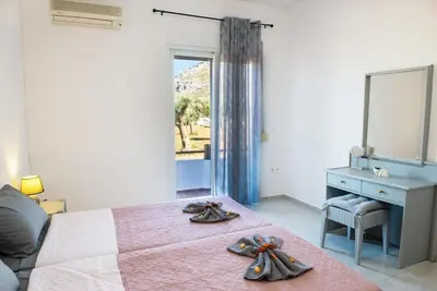 a bedroom with a bed with a dresser and a mirror at Atlantic Cave Haven-Seaside, Fully Equipped in Kolimbia