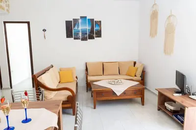a living room with a couch and a table at Atlantic Cave Haven-Seaside, Fully Equipped in Kolimbia