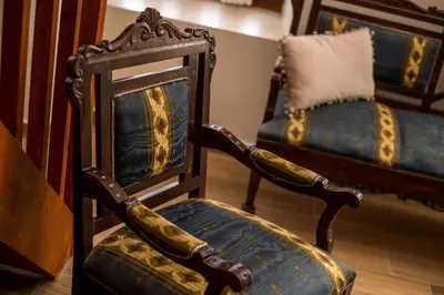 an old chair and a couch in a room at The Knight's House Old Town Rhodes in Rhodes Town