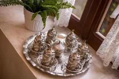 a group of glass cats on a plate on a window sill at The Knight's House Old Town Rhodes in Rhodes Town