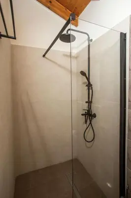 a glass shower in a bathroom with a ceiling at The Knight's House Old Town Rhodes in Rhodes Town