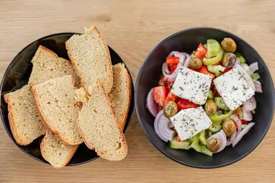 two bowls of food with a salad and a sandwich at Villa Tranquility in Psinthos