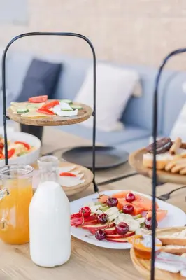 a table with plates of food and a bottle of milk at Villa Tranquility in Psinthos