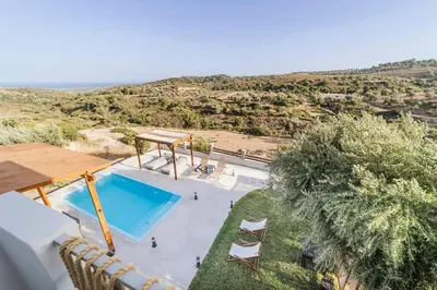an overhead view of a swimming pool in a villa at Villa Tranquility in Psinthos